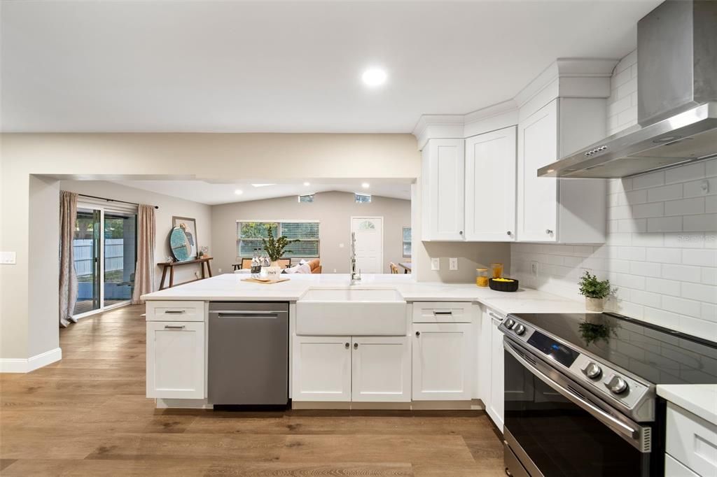 Gleaming quartz countertops and porcelain apron-front farmhouse sink