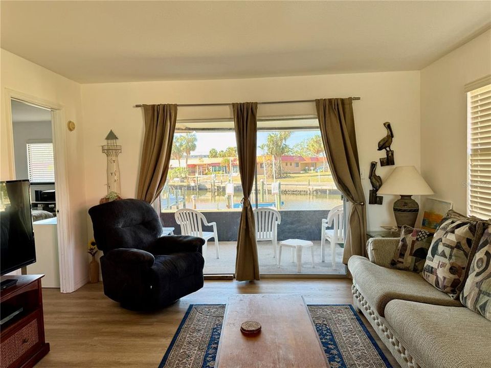 Entry with view to canal from dining, living and screened in lanai.