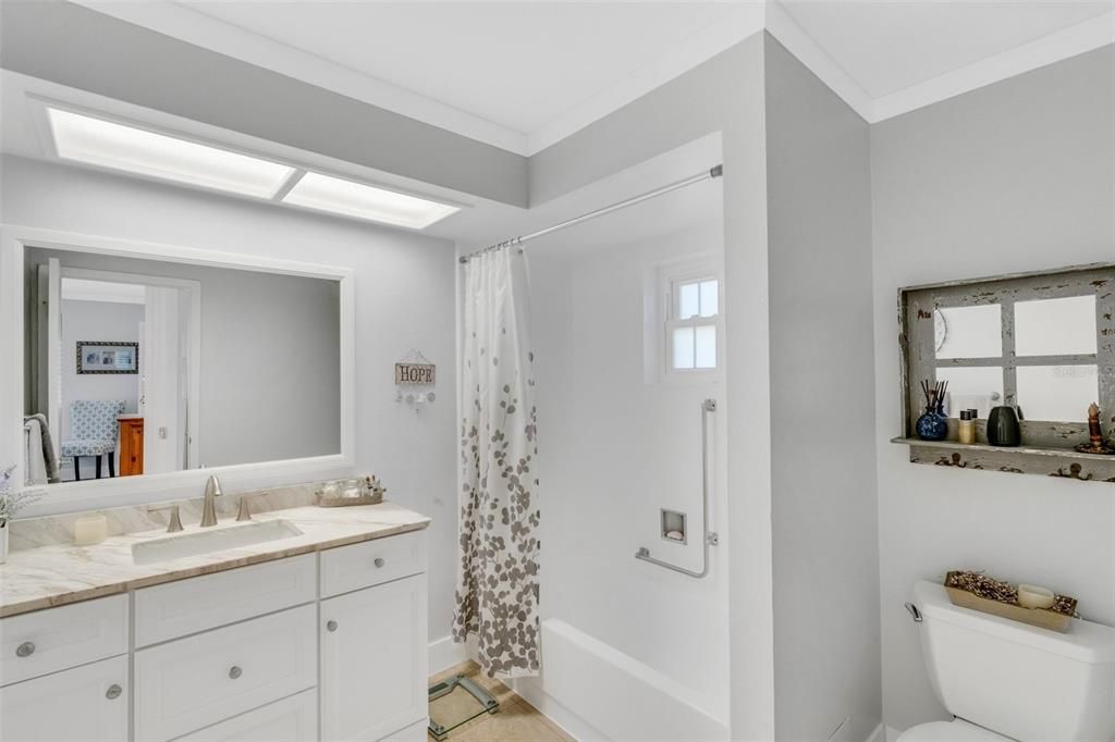 Lovely en-suite with marble countertop, updated vanity, & tub/shower combo~