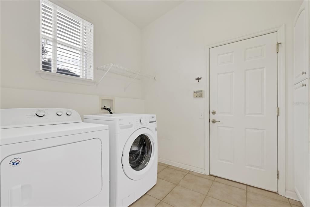 Dryer conveys.  Washer does not. Pass through to garage.  Wall of cabinets to right.