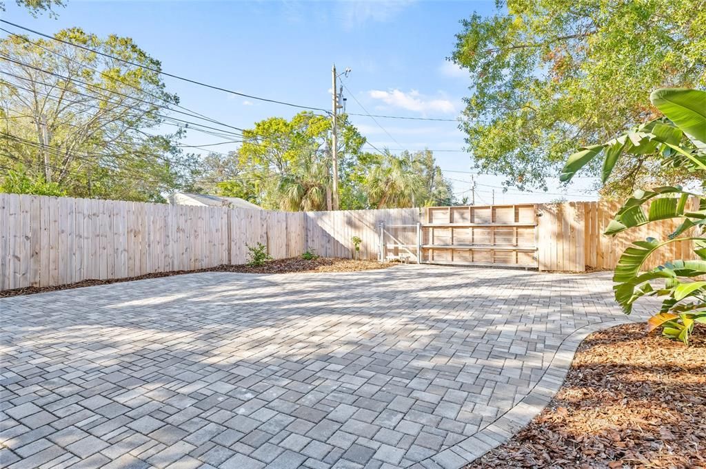 Alley access with a gated driveway ready for motorized opening. New fence (2023).