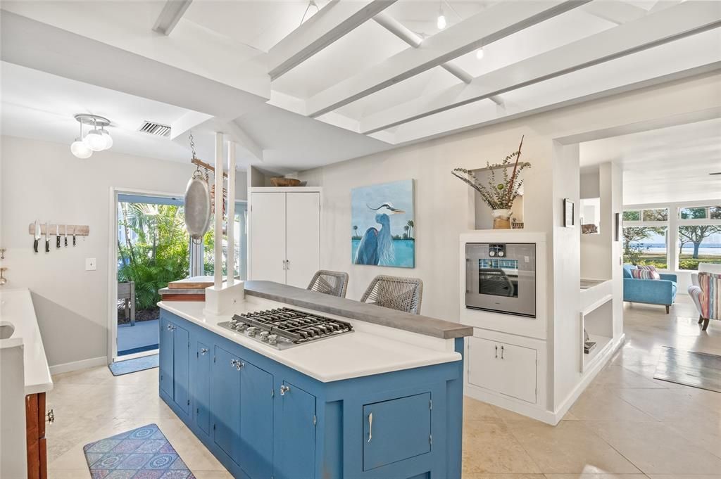 The fully upgraded kitchen, completed in 2020, is a chef's dream. Featuring sleek concrete gray and white quartz countertops, top-of-the-line KitchenAid gas appliances...