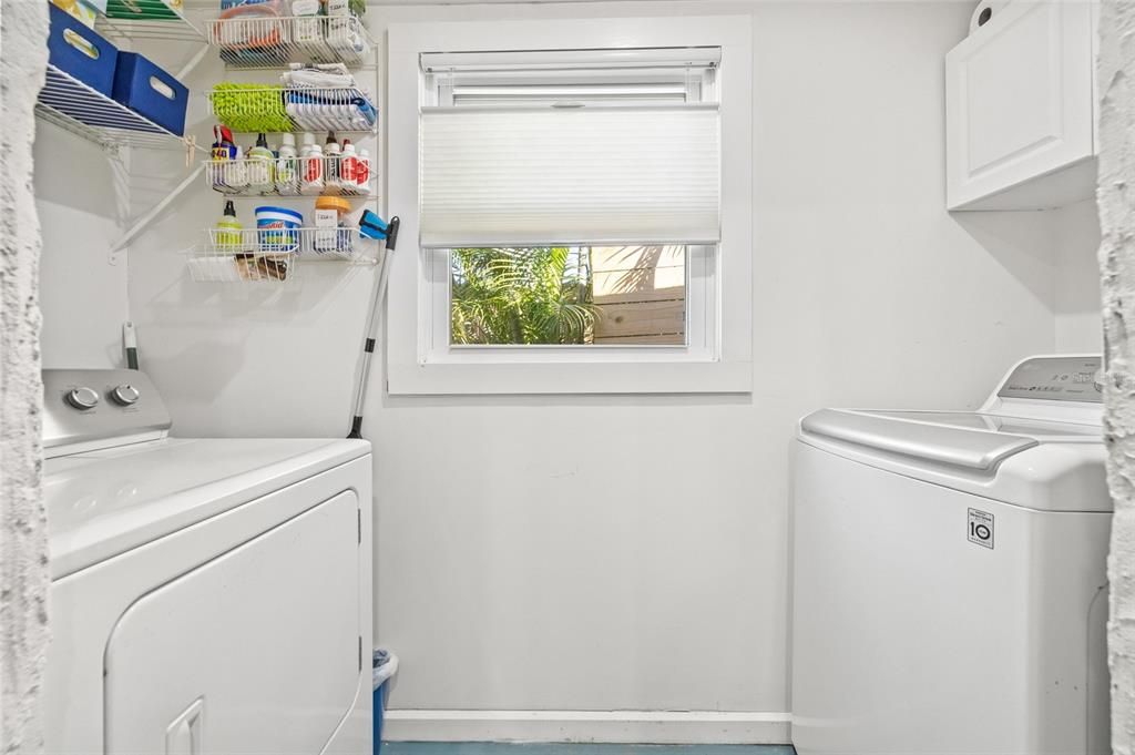 The laundry area has extra cabinets and shelving ready to storage your cleaning supplies.