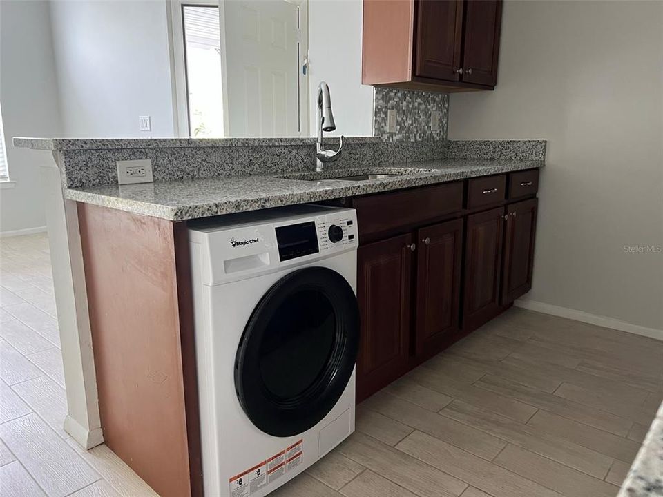 laundry unit inside the unit, under counter