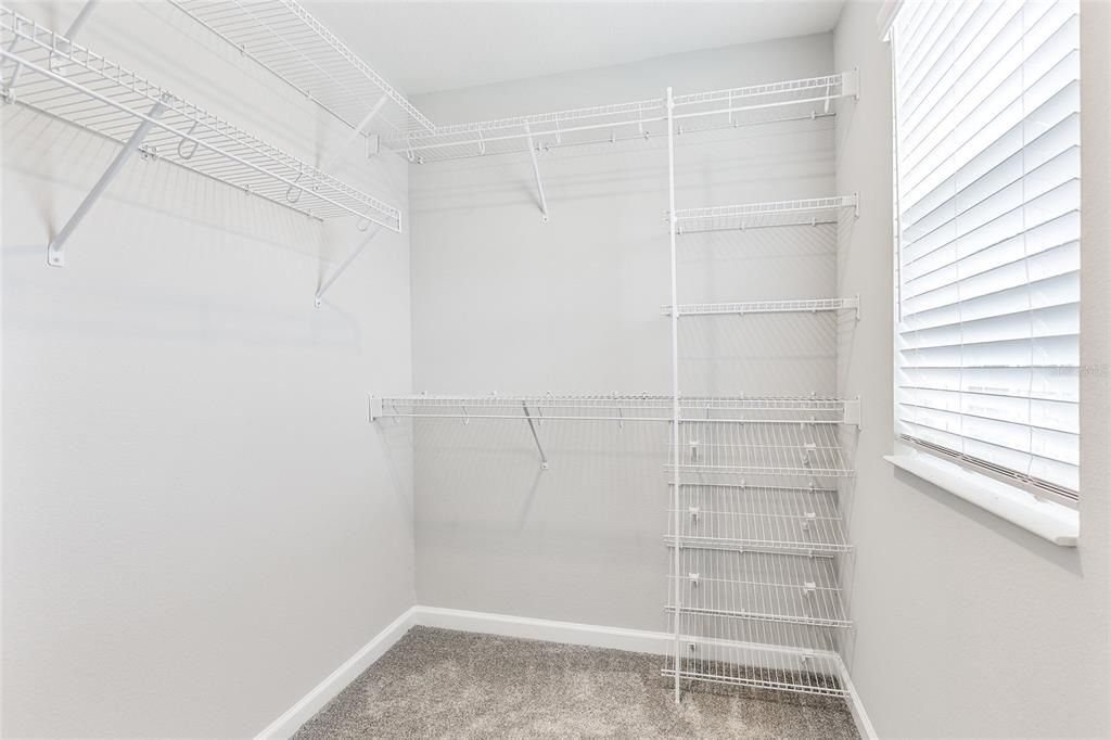 Walk in closet in primary bedroom