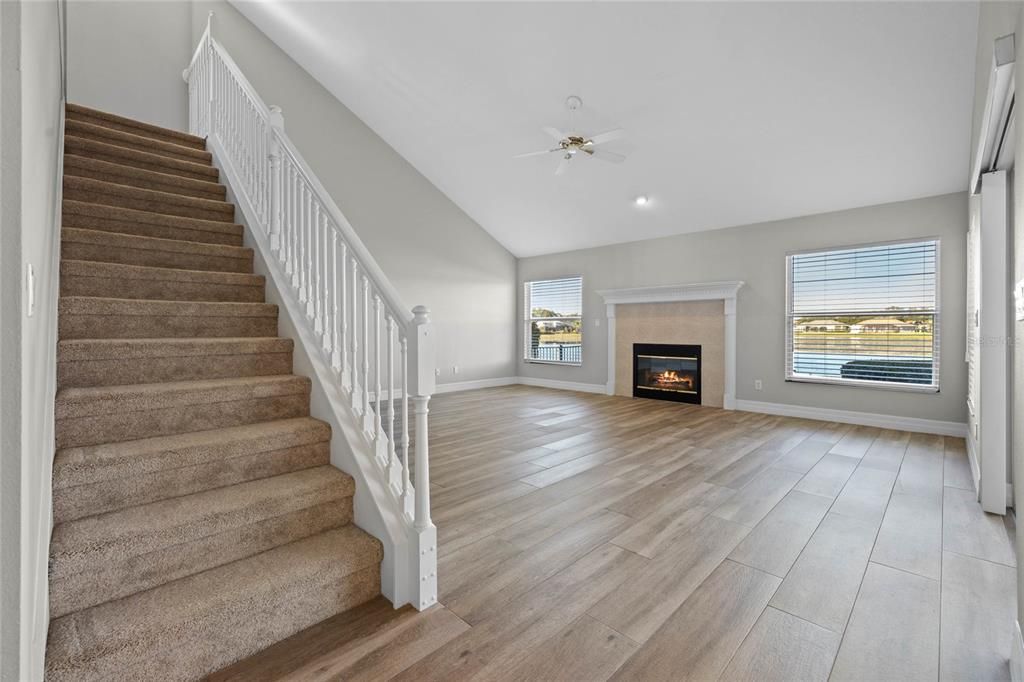 Family RoomOpen-concept space connected to the kitchen for seamless entertaining.Sliding doors lead to the pool area and fully fenced backyard.Enjoy unobstructed lake and pool views with no rear neighbors.Overlooked by the spacious loft, adding a unique architectural touch.