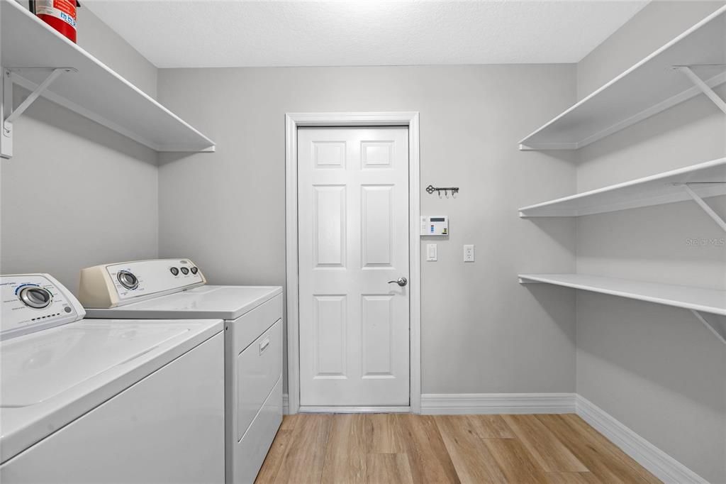 Spacious laundry room with ample storage, utility sink, and convenient access—making chores a breeze!