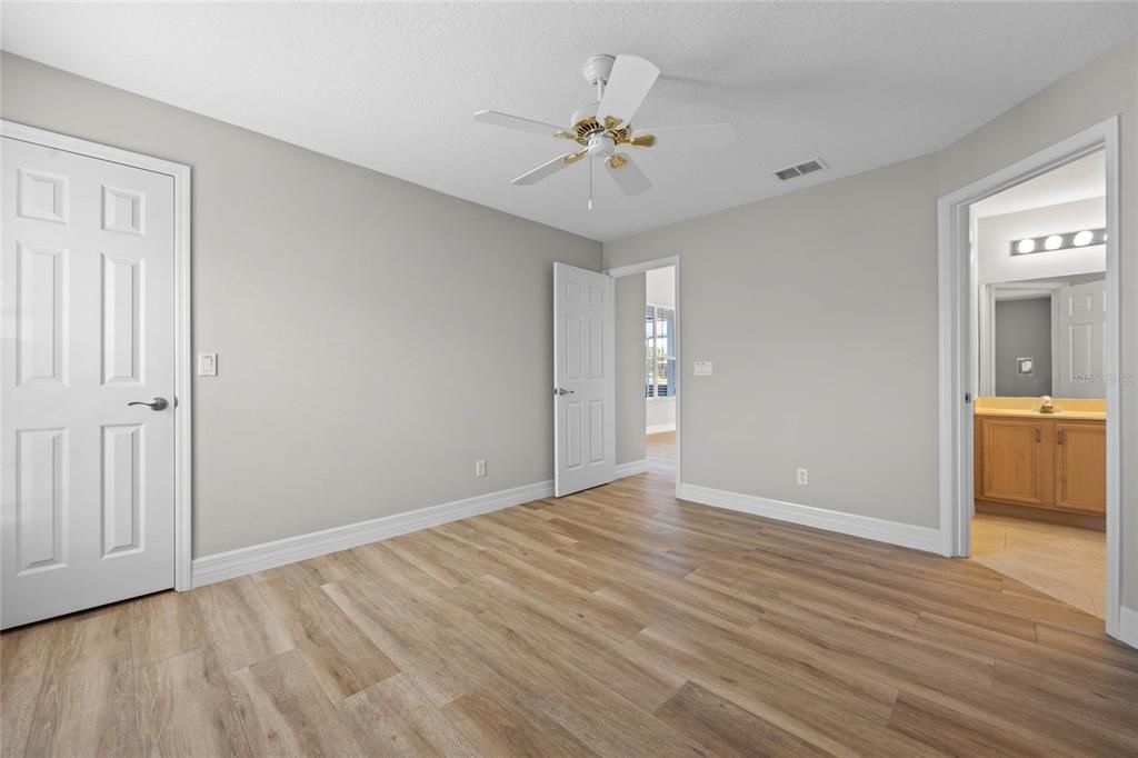 Bedroom 2Spacious room with wood-look tile flooring and fresh paint (2024).Ample under-stair storage in the closet, perfect for organization.