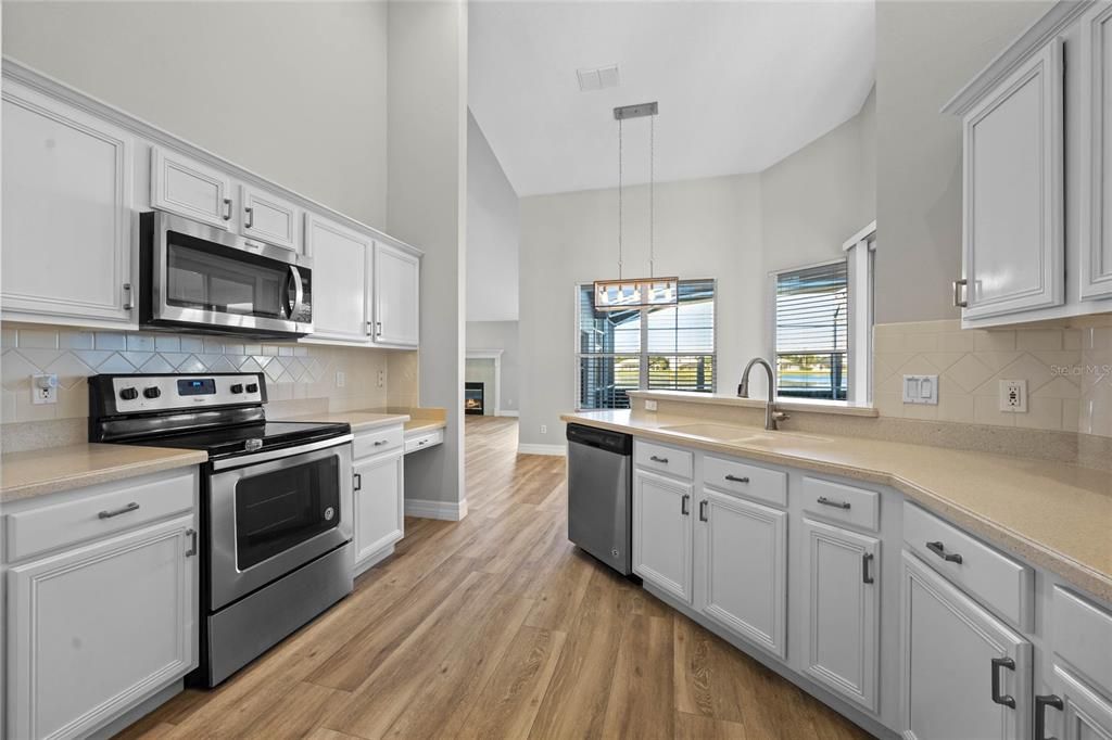 Kitchen & Dinette Renovated kitchen with stone countertops and custom pantry shelving.Newer Whirlpool stainless steel appliances (2020).Breakfast nook offers tranquil lakefront views for your morning coffee.Refinished cabinetry adds a modern yet timeless touch.