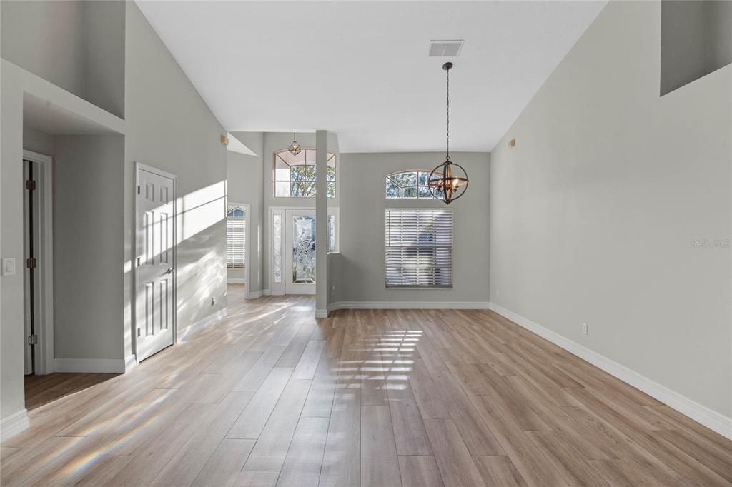 FoyerLight-filled entryway with a glass insert in the front door, offering street views and natural light.Open plan provides stunning sightlines to the lake, pool, and living room.Seamlessly connects to the living room, dining room, and 4th bedroom/office at the front of the home.