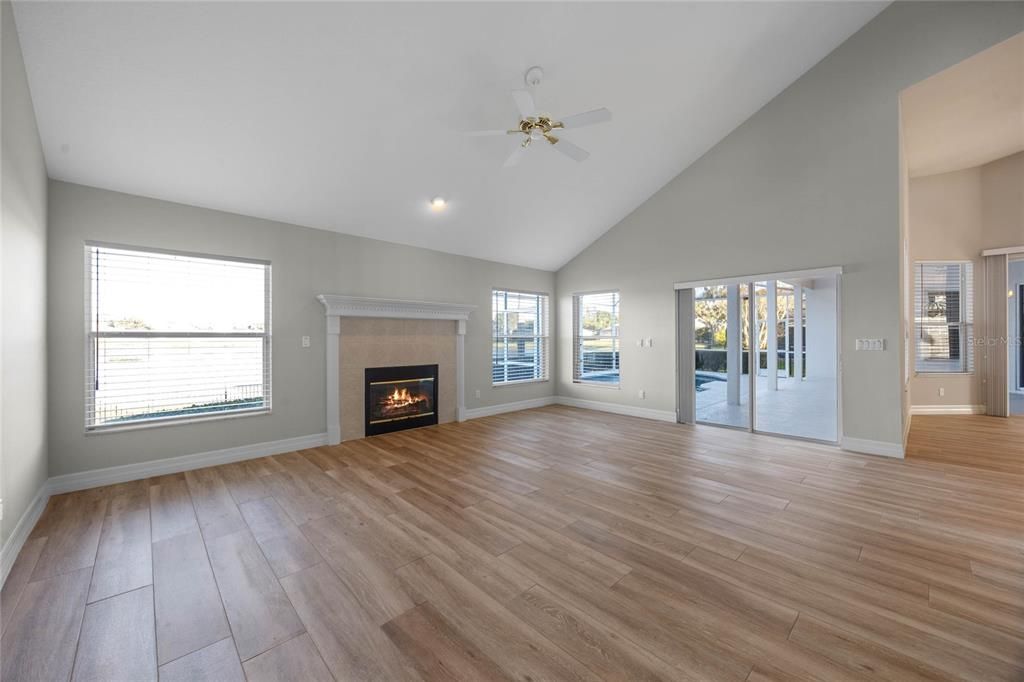 Family RoomOpen-concept space connected to the kitchen for seamless entertaining.Sliding doors lead to the pool area and fully fenced backyard.Enjoy unobstructed lake and pool views with no rear neighbors.Overlooked by the spacious loft, adding a unique architectural touch.