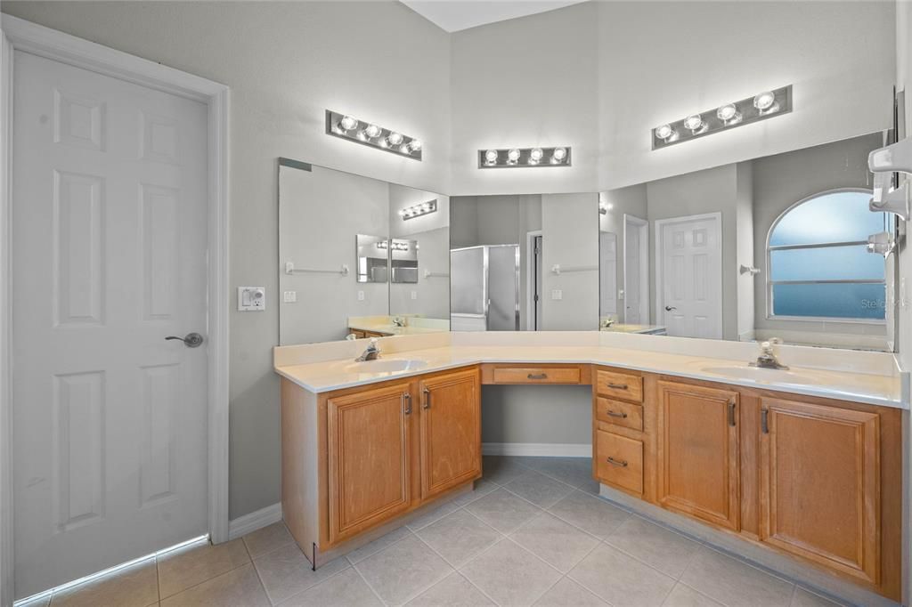 Primary BathroomRelax in the soaking garden tub surrounded by bright natural light.Spacious layout with dual vanities for added convenience.High ceilings enhance the open and airy feel.