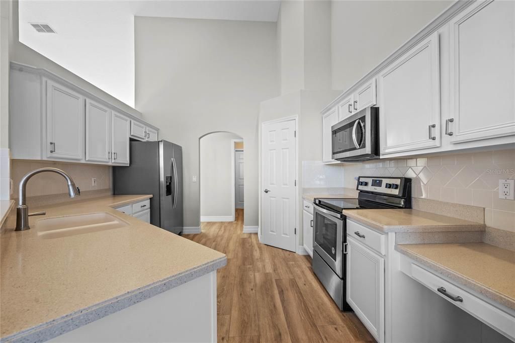 Kitchen & Dinette Renovated kitchen with stone countertops and custom pantry shelving.Newer Whirlpool stainless steel appliances (2020).Breakfast nook offers tranquil lakefront views for your morning coffee.Refinished cabinetry adds a modern yet timeless touch.