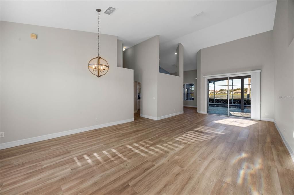 Dining Room:Host elegant dinners in the dining room with soaring vaulted ceilings and fresh paint, complemented by breathtaking lake views through the open, airy layout.