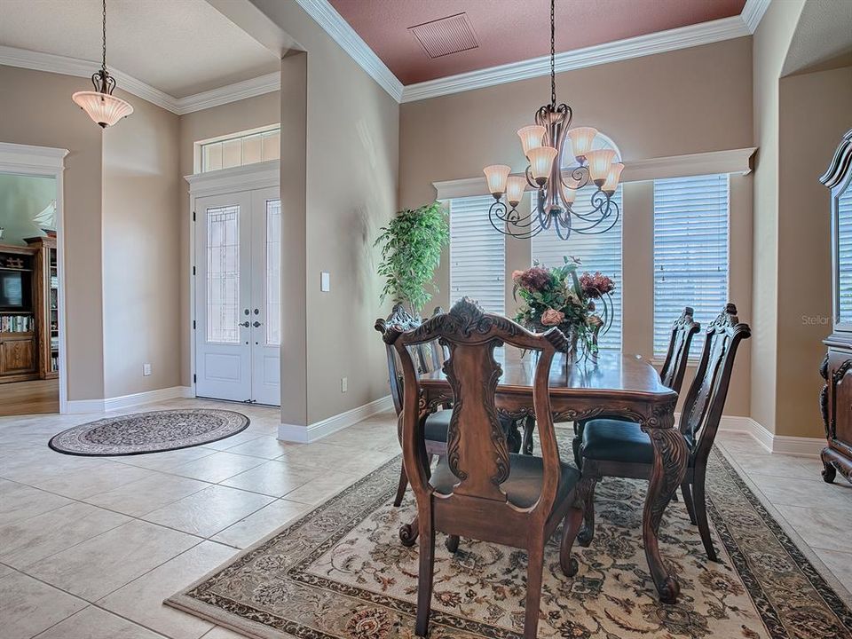 LOVELY TILE FLOORING IN THE FOYER AND DINING ROOM AND FLOWS INTO LIVING ROOM, FAMILY ROOM, KITCHEN AND HALLWAYS.