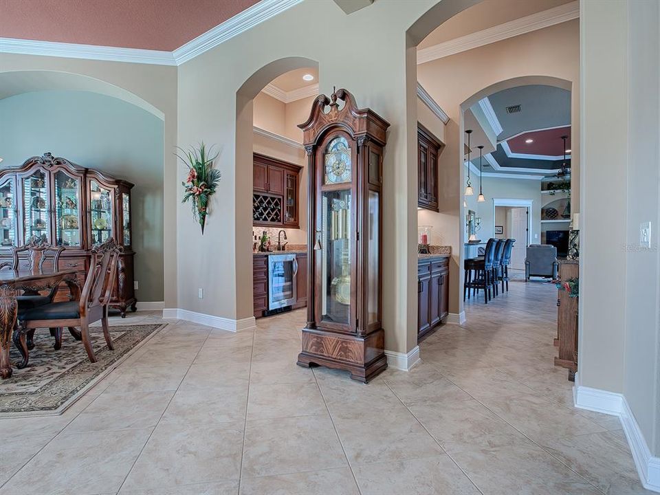 ARCHWAYS LEAD YOU THROUGH THE WINE/BAR WITH SINK AND BEVERAGE REFRIGERATOR ON THE LEFT AND BUTLER'S PANTRY ON THE RIGHT ON THE WAY TO THE KITCHEN.