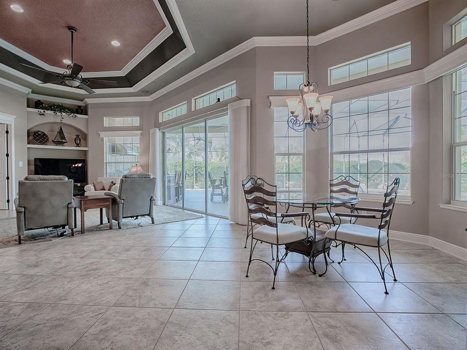 CASUAL DINING AREA AND FAMILY ROOM WITH A GREAT VIEW OF THE POOL.