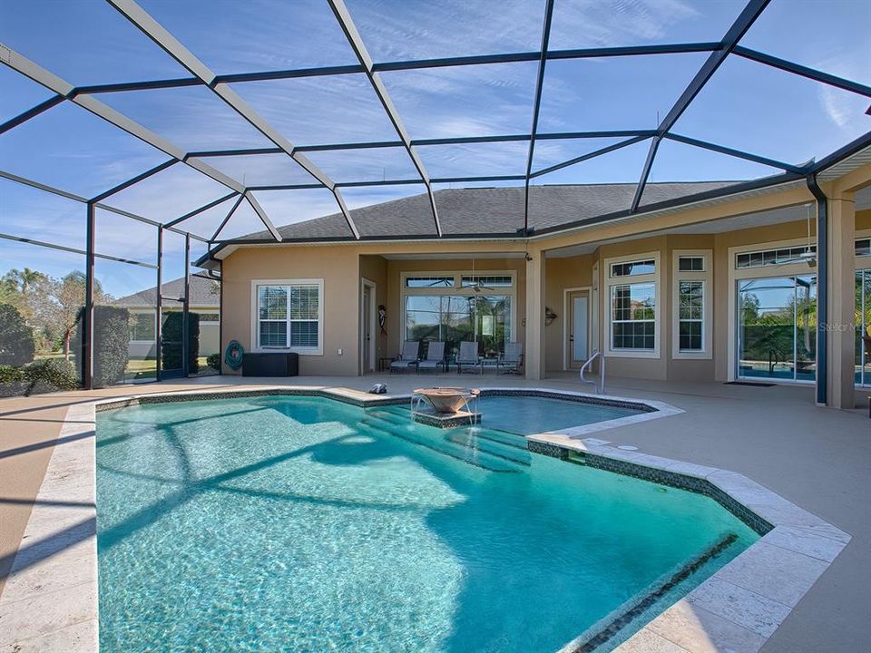 LOVELY HEATED POOL WITH TRAVERTINE COPING AND COPPER BOWL WATERFALL.