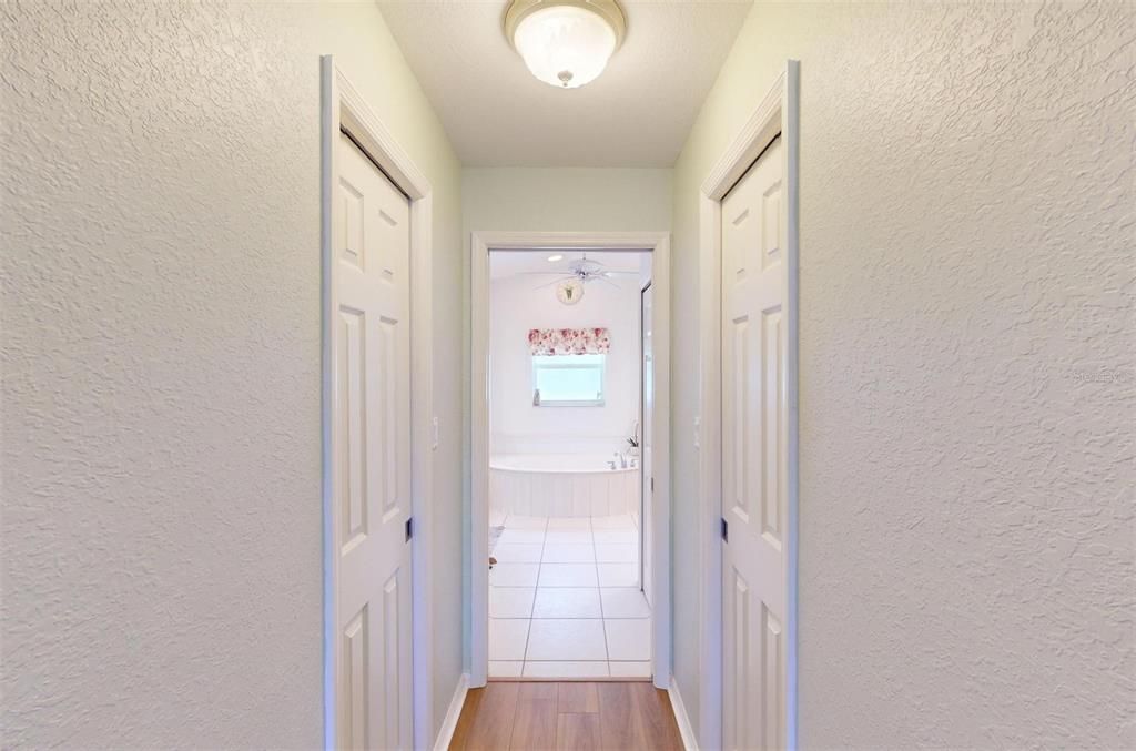 Primary hallway to bath with 2 walk-in closets