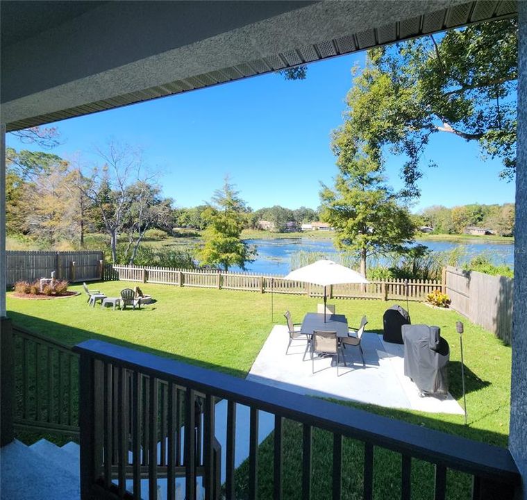 View of back yard and private lake from covered lanai