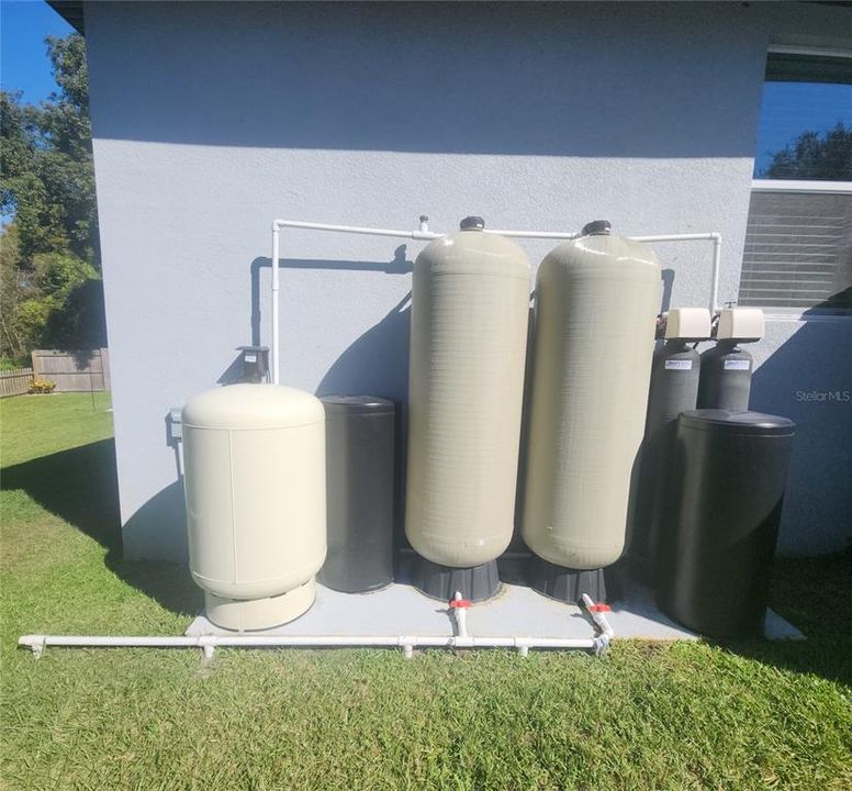 Bleach injection water purification system with two stage filtration and water softener