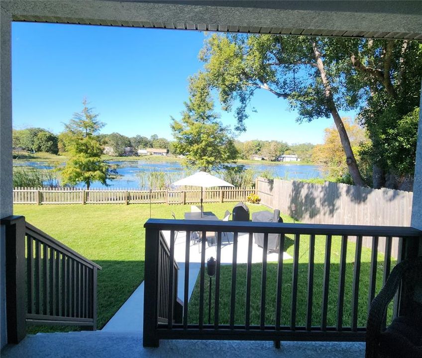 View of back yard and private lake from covered lanai