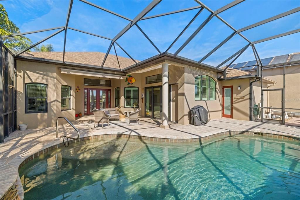 Pool showing covered space and motorized awning