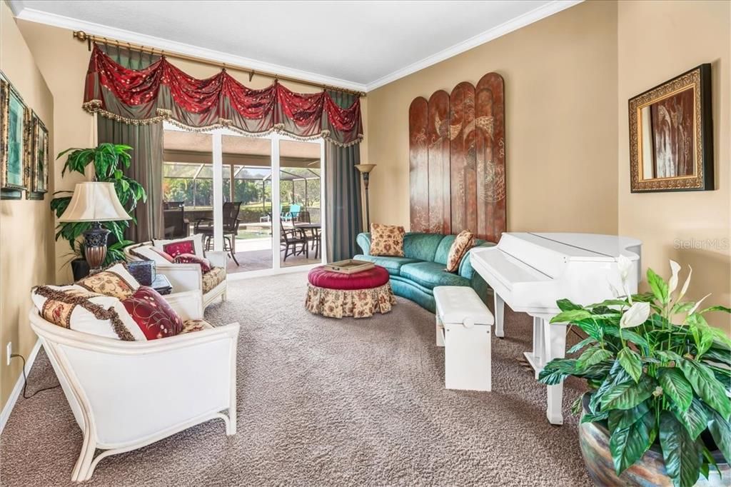 Livingroom with sliders out to the pool and covered lanai