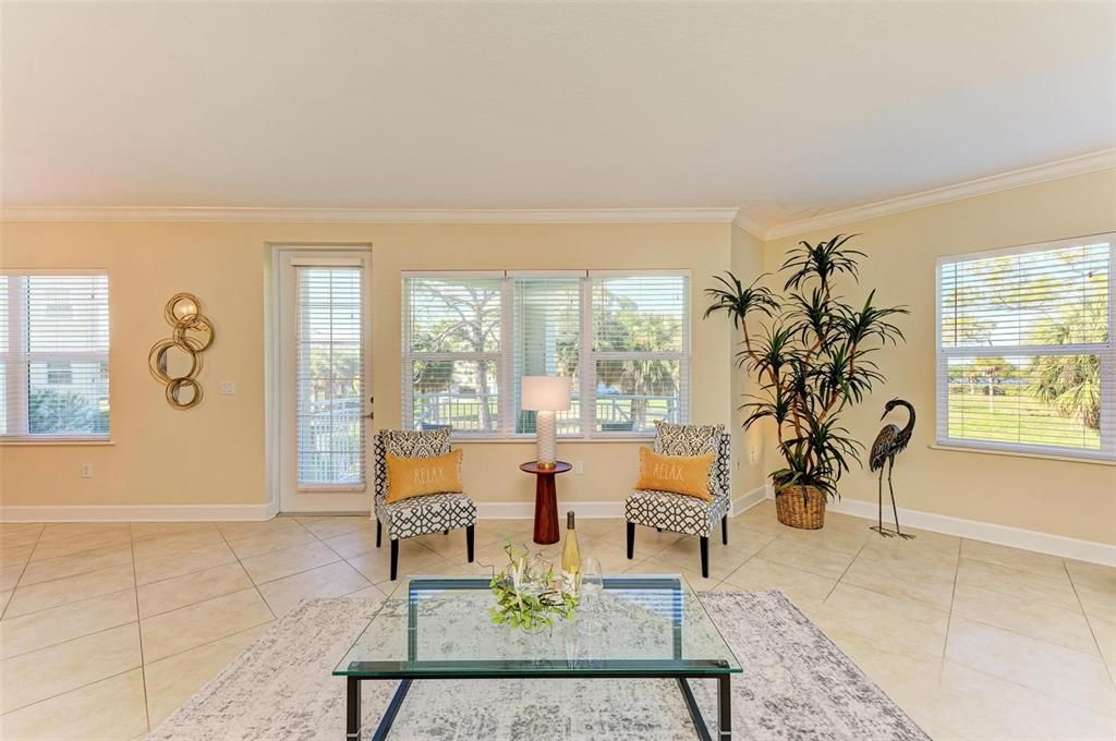 Living area leading to balcony with view of Palma Sola Bay through the windows.