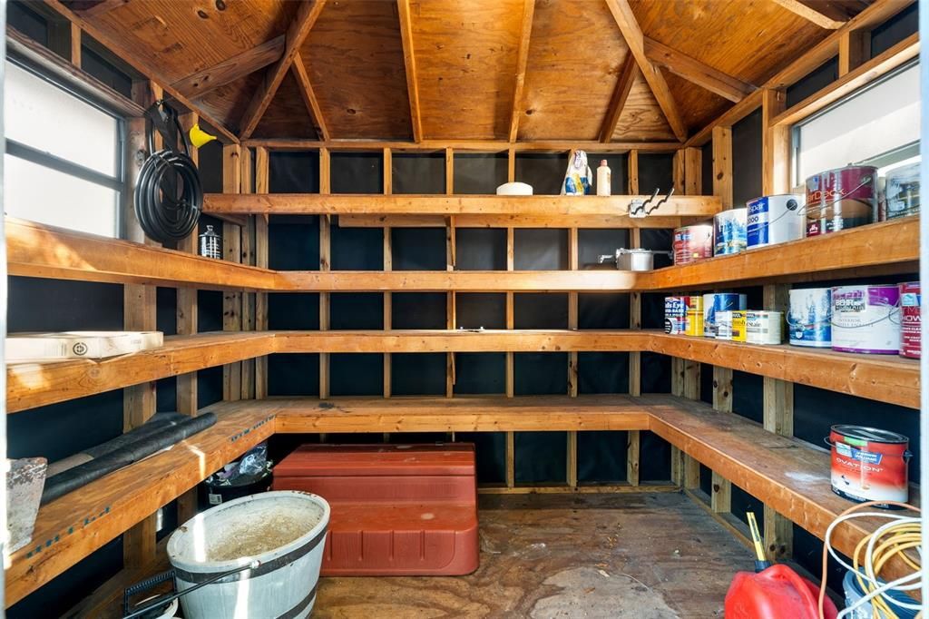 Shed interior offering lots of storage, natural light as well as electric.