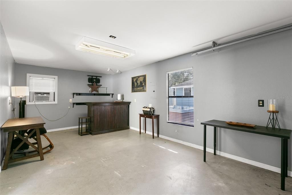 Single bay (3rd) garage with privacy wall  and AC units. Making this space multi-use.