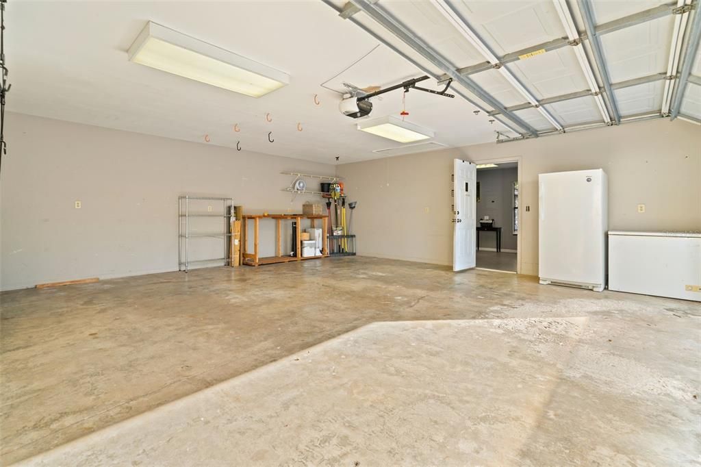 2 car garage showing the privacy wall  and door entering the single car garage with climate controls.