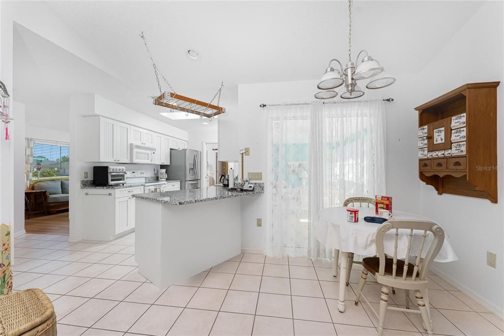 Kitchen has upgraded cottage cabinetry and granite countertops