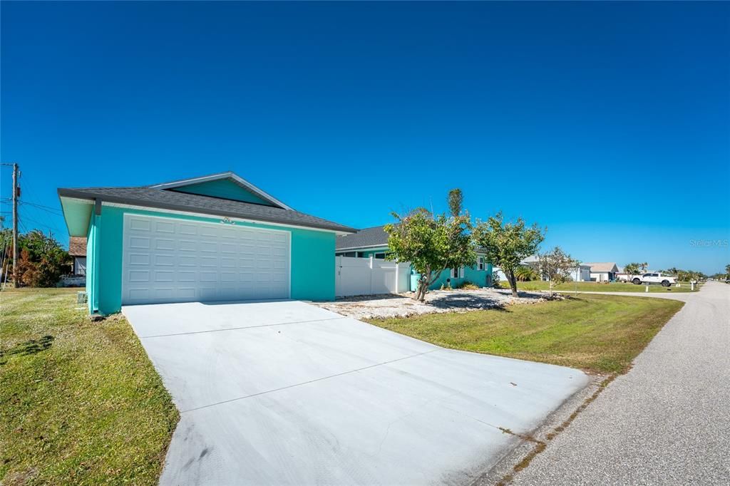 Full side view of the house and detached garage