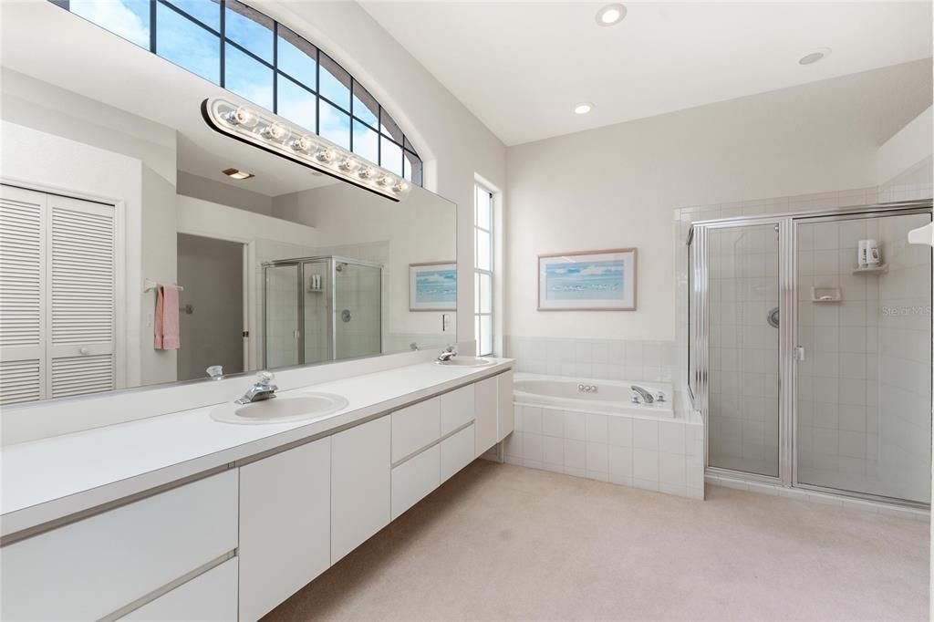 The master bath with tub and shower and double vanities.