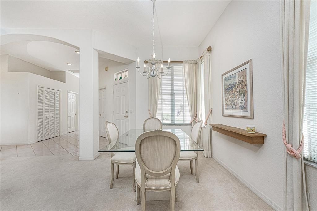 Dining room, foyer, den (the closed door in the background) and an entry storage closet.