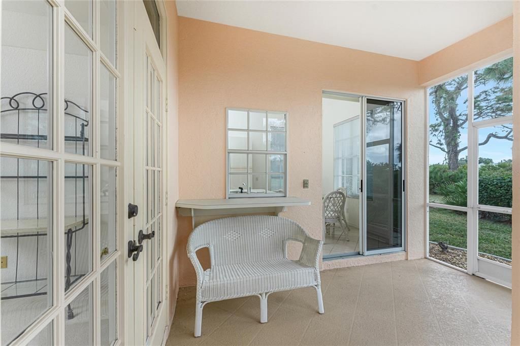 Lanai with passthrough from the kitchen, patio doors into the breakfast nook and kitchen.  The French doors to the left lead into the living room.