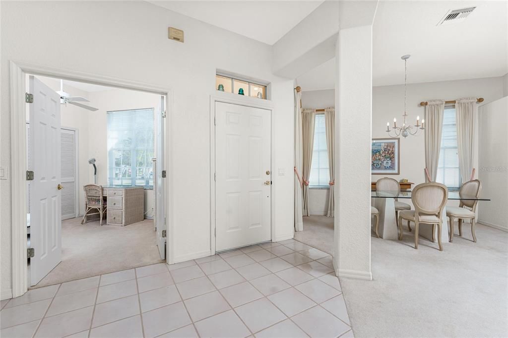 Tiled foyer, den with French doors, and a formal dining room.