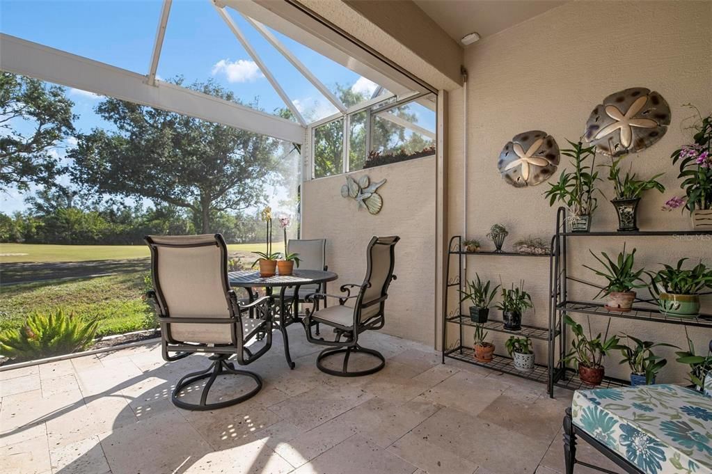 Lanai with travertine flooring and panoramic screen