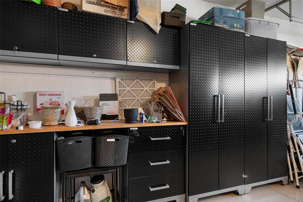 Garage with beautiful built-in cabinets and drawers, counter space