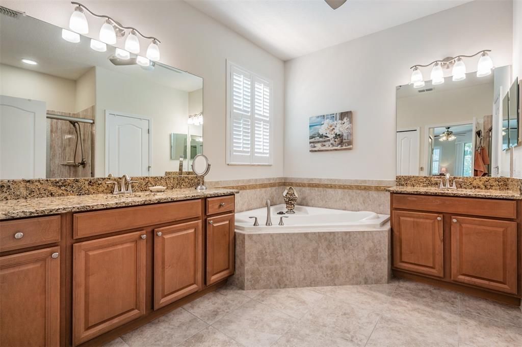 Dual vanities with soaking tub in the center