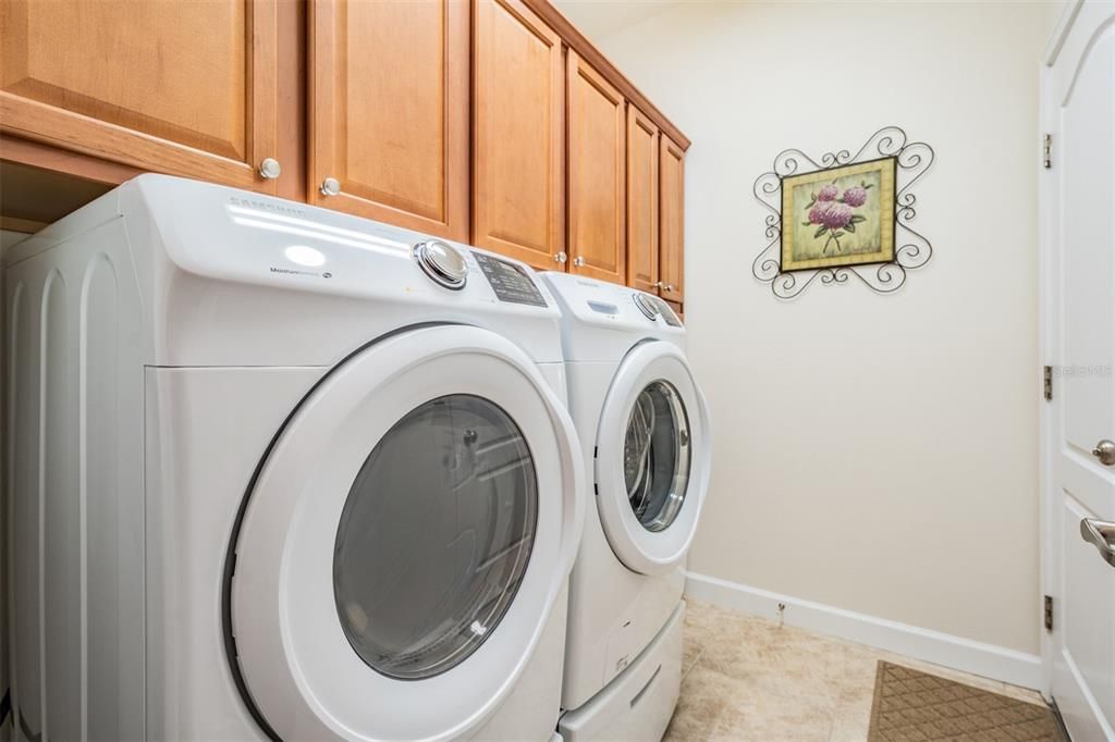 High efficiency washer and dryer with custom cabinets above