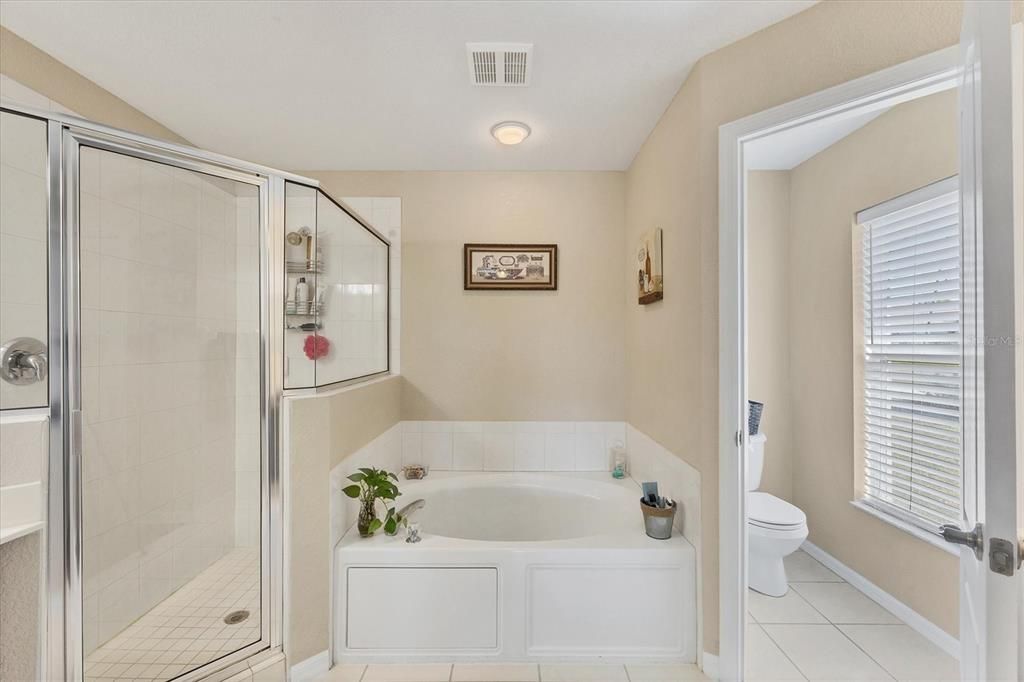 An ensuite bath offers split dual vanities, a shower, a large soaking tub, and a private water closet.