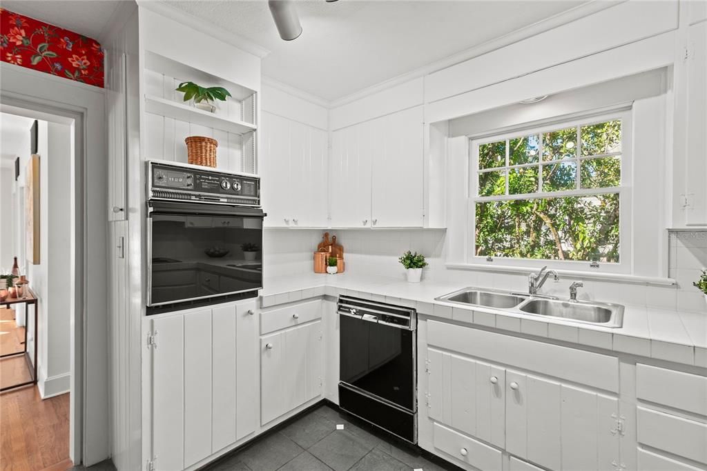 Tiled countertops, wood cabinets and vintage applicances.