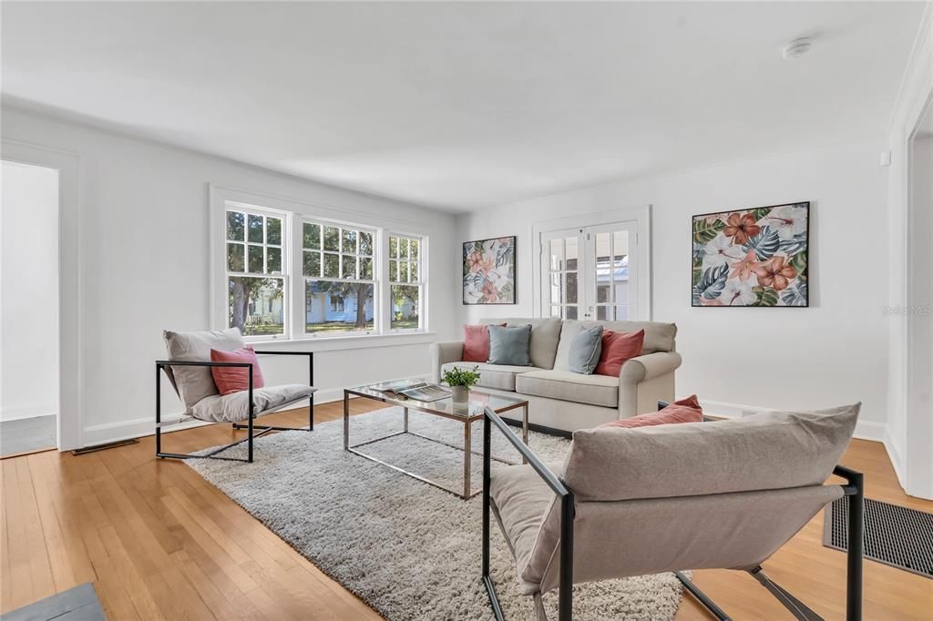 French doors lead to the screened side porch.