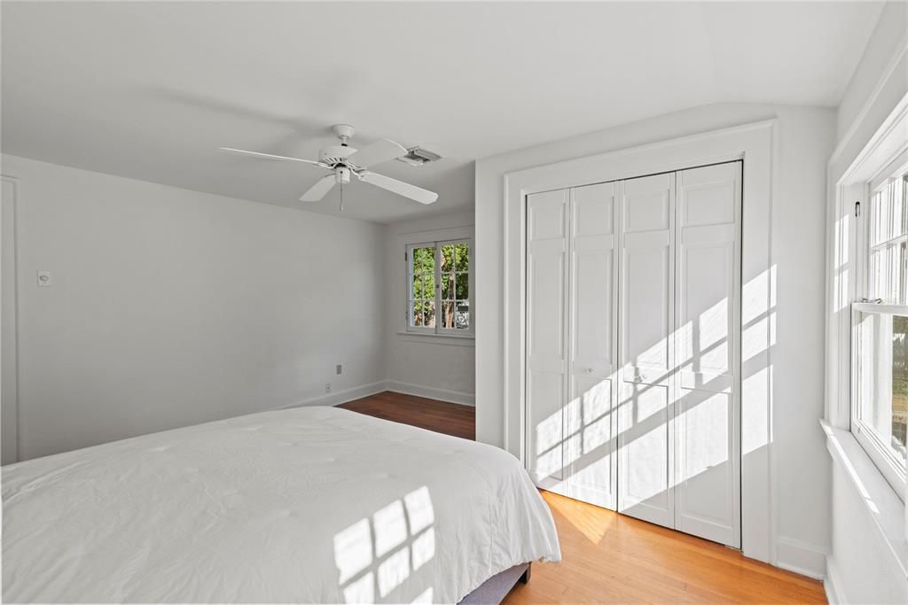 Primary bedroom beams with natural light.