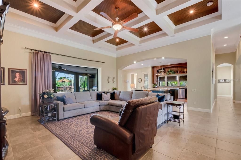 The family room and a view into the kitchen and stunning outdoor living space