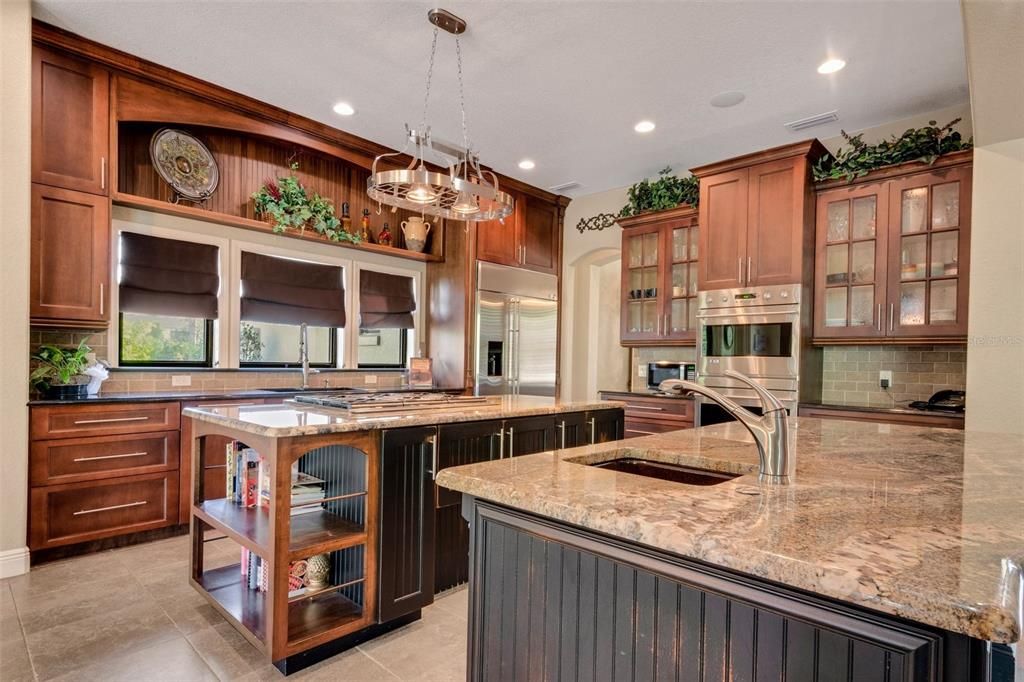 The kitchen is surrounded with stunning solid wood cabinetry. Floor to ceiling storage along with a walk-in pantry and , again ...two islands.