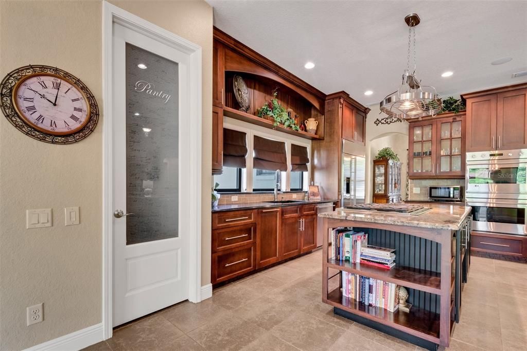 The walk-in pantry is oversized & has plenty of storage and shelving