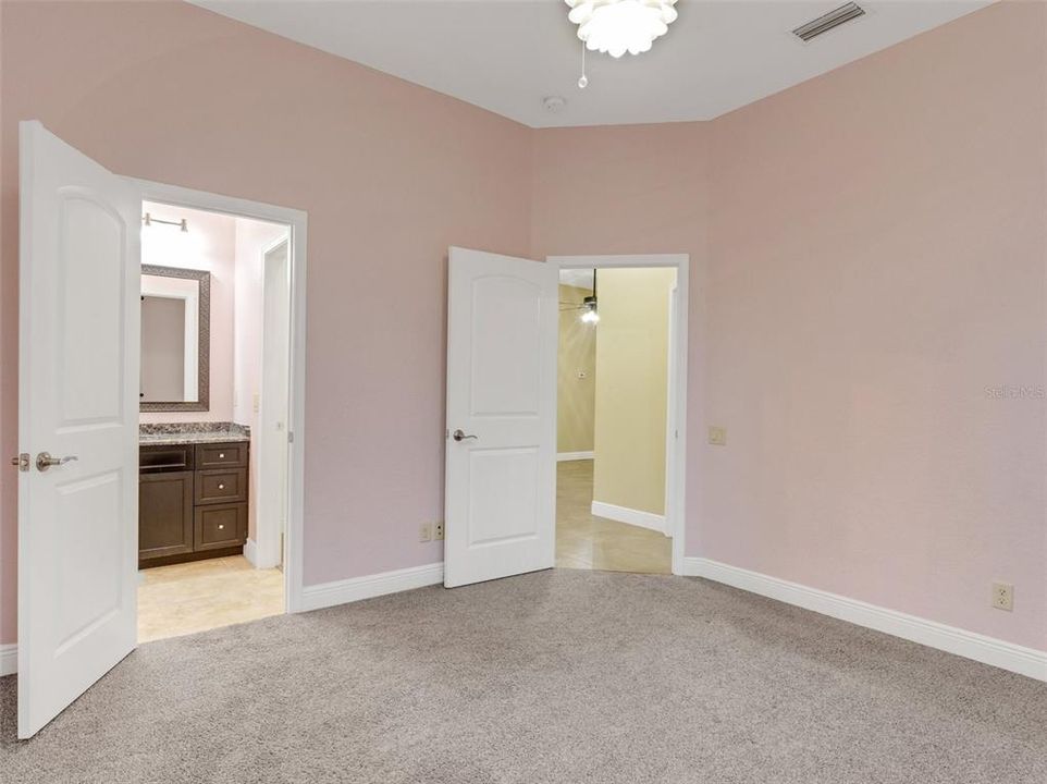 Bedroom #2 and the entrance in a private vanity/walk-in closet space.